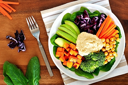 Healthy lunch bowl with avocado, hummus and vegetables